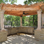 A custom pergola over a paved patio.